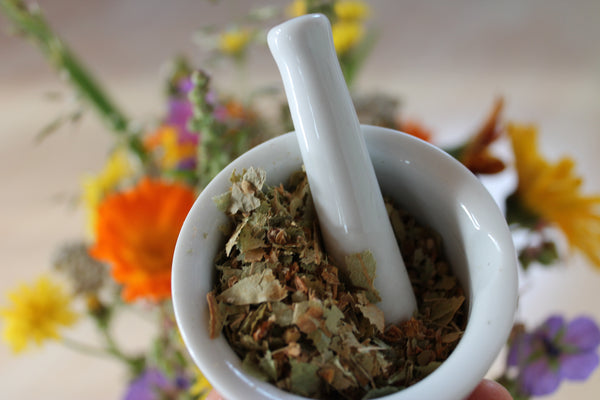 An ayurvedic bowl with semi-crushed dried leaves