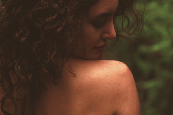 Lady showing her bare, beautiful back skin and face
